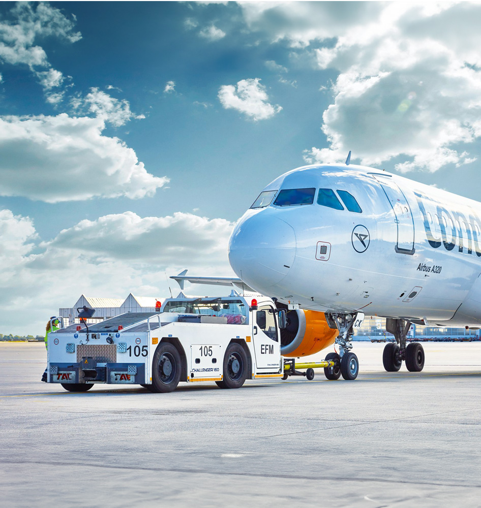 Aircraft towing with pushback tractor on airport apron