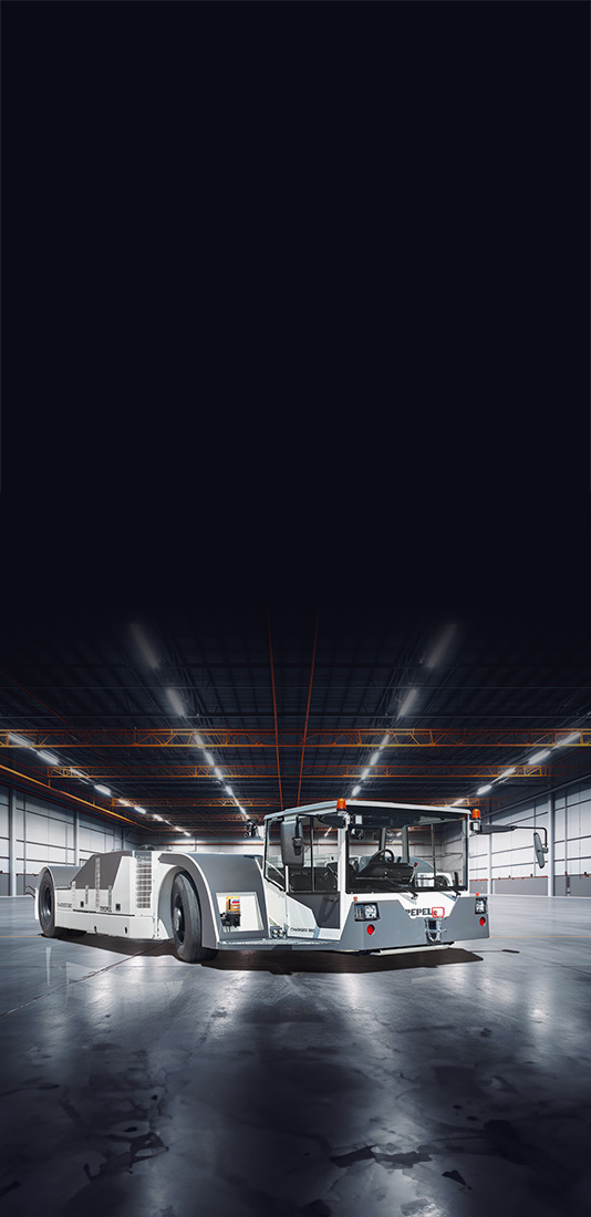 TREPEL CHARGER aircraft tow tractor in illuminated industrial hall