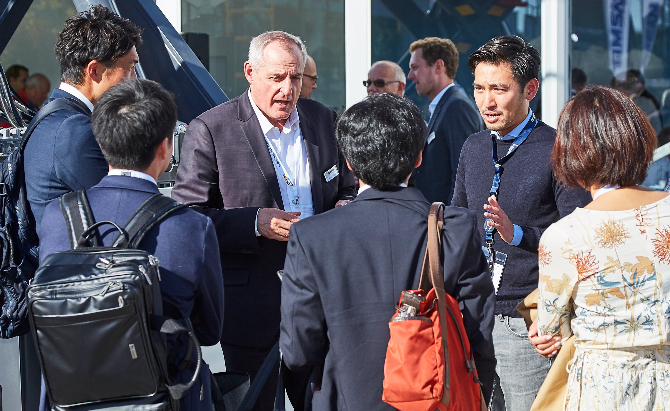 TREPEL-Mitarbeiter im Gespräch mit einer internationalen Besuchergruppe auf der Messe